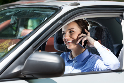 Happy woman driving car